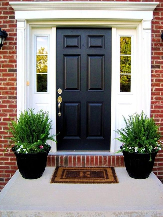 Deep Black Door With Brick Contrast