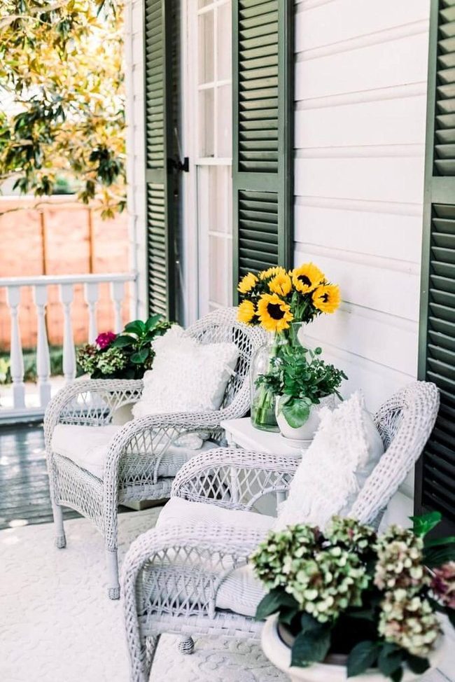 White Wicker Porch With Sunset Flowers