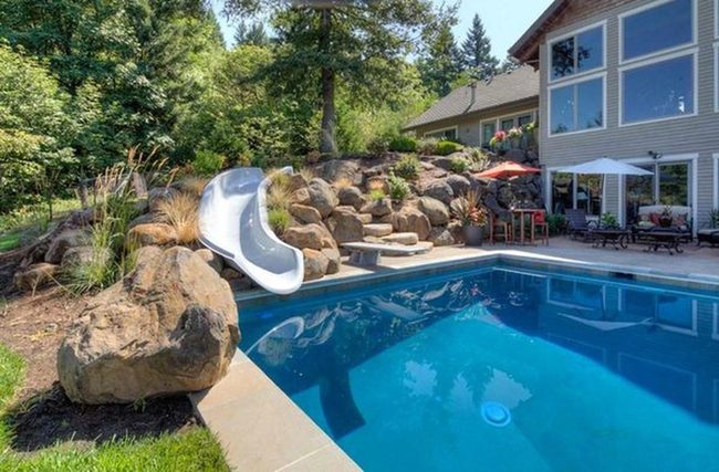 Stone-Framed Pool With Water Slides