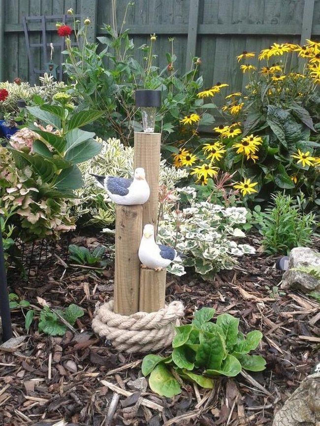 Wooden Birds Among Living Flowers
