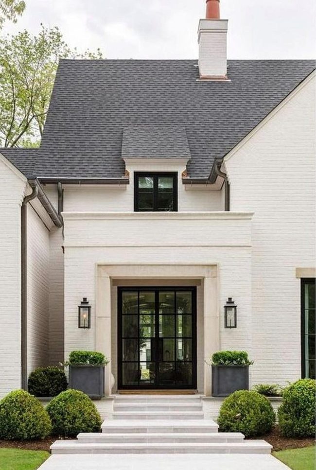 White Brick Home With Black Frame Windows