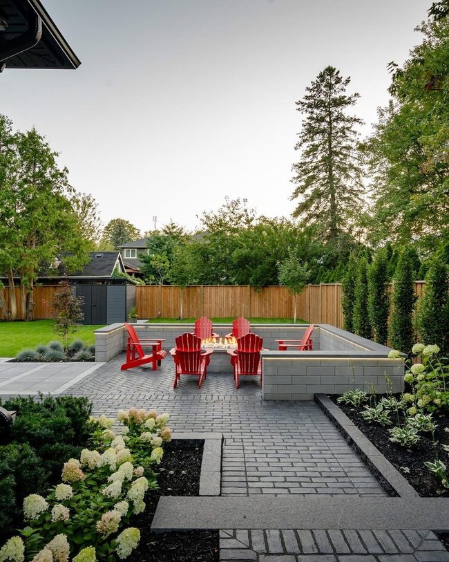 Red Chairs Among Emerald Hedges