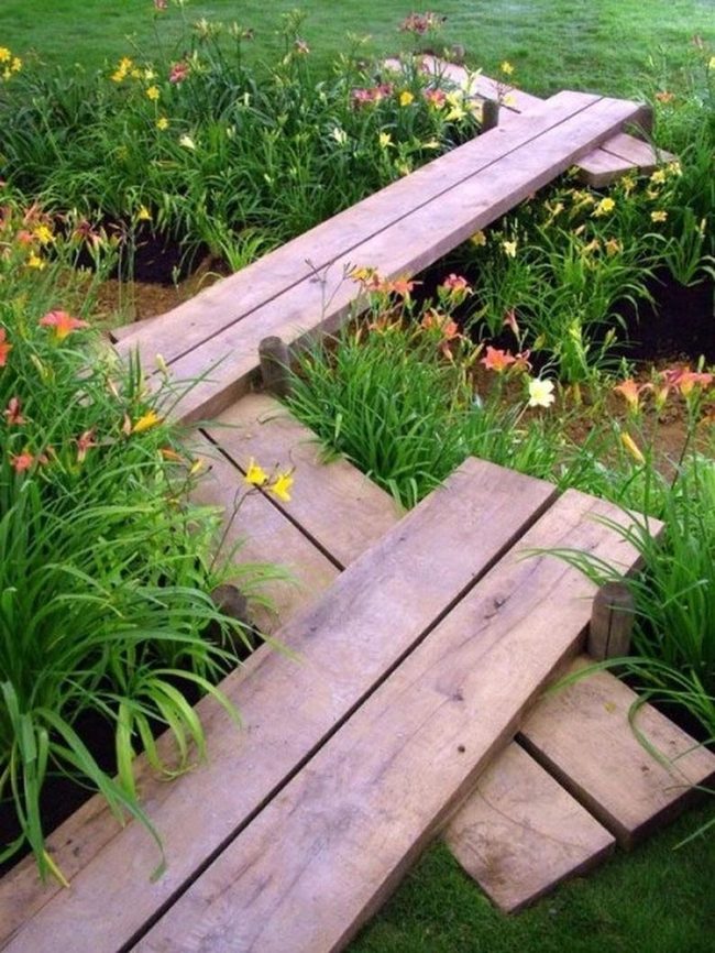 Weathered Bridge Through Blooming Garden