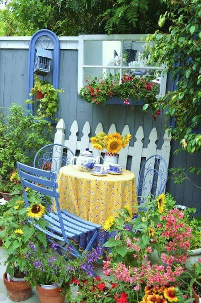 Yellow Table In Blooming Garden Corner