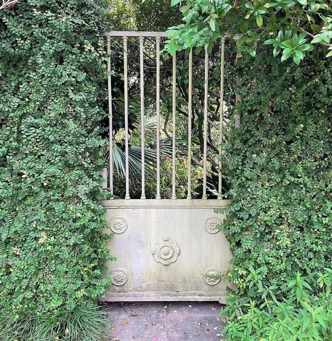 Carved Wood Gate Among Green