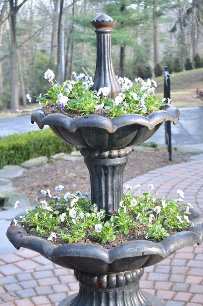 White Blooms In Metal Garden Fountains