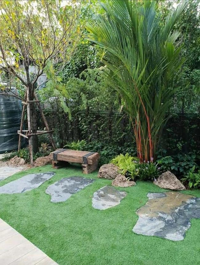 Garden Benches Among Blooming Flowers