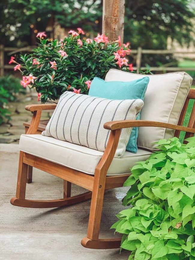 Wooden Rocker Among Blooming Plants