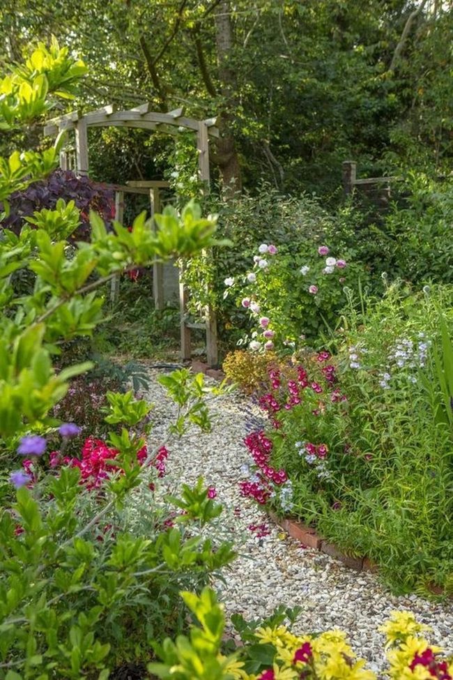 White Stone Path Through Blooming Garden