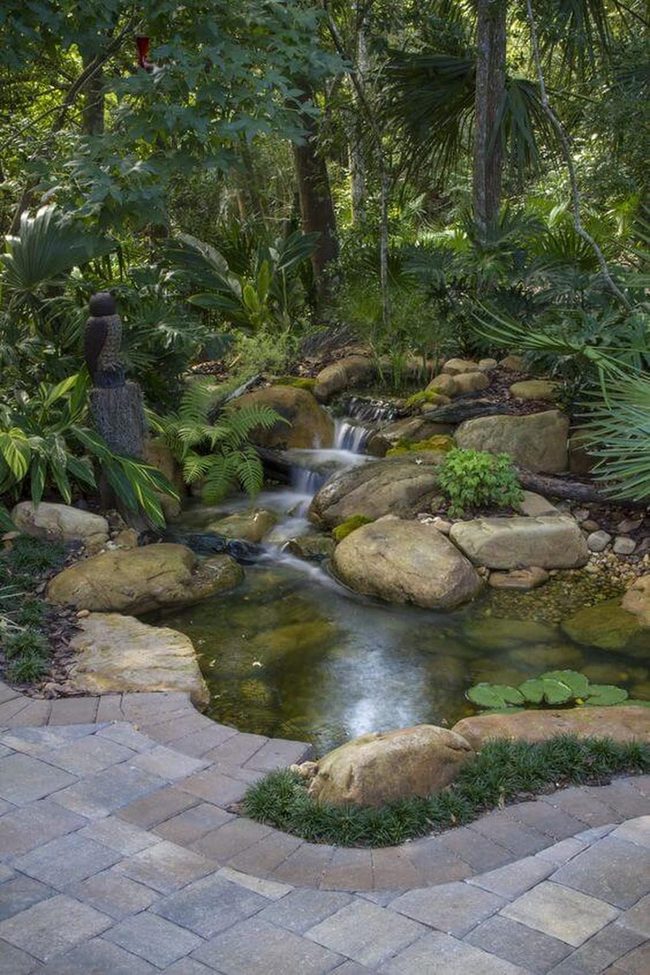 Cascading Water Over Smooth Garden Stones