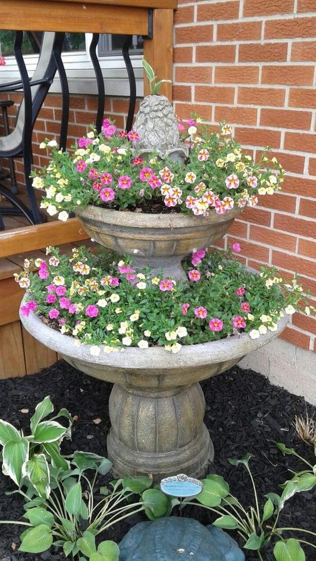 Stone Tiered Planter With Cascading Blooms