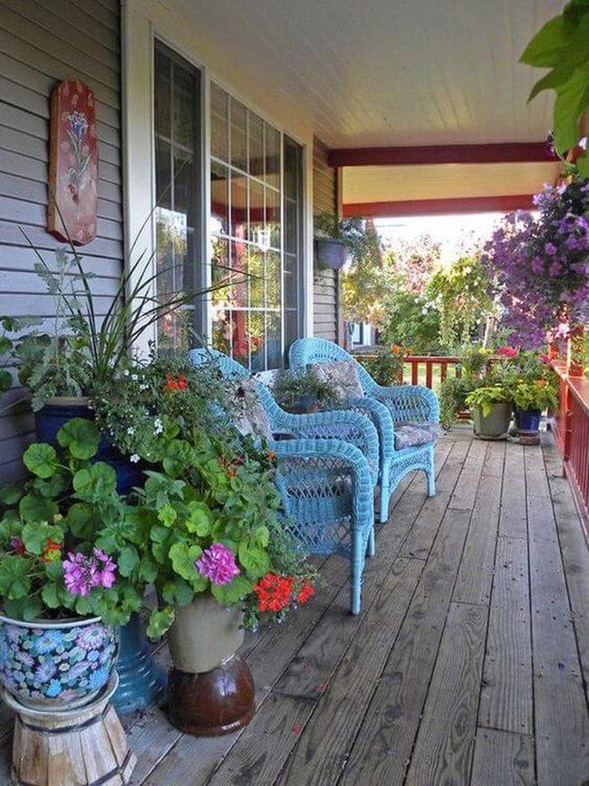 Blue Wicker Porch With Blooming Planters