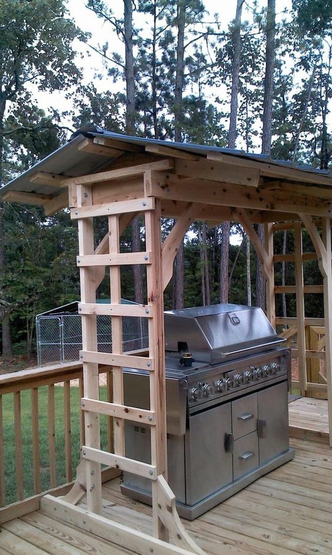 Stainless Steel Grill Among Towering Pines