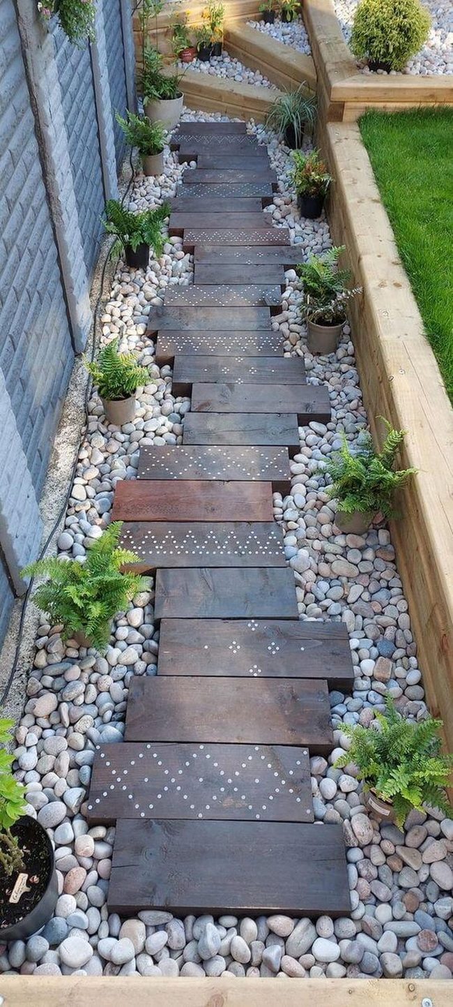 Wooden Planks Through Fern-Lined Garden