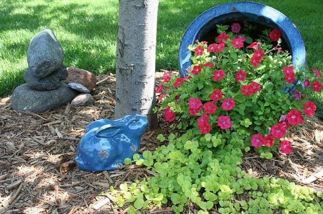 Bunny Statues Among Blooming Flowers