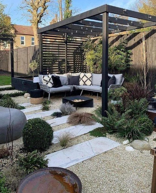 Black Furniture Beneath Blooming Pergola