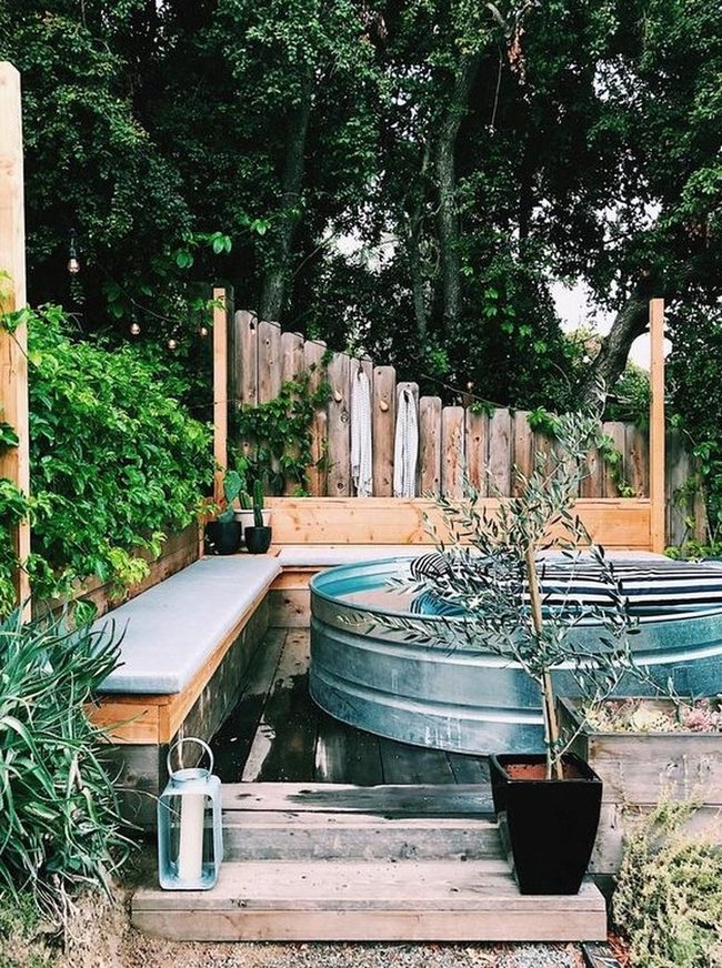 Metal Soaking Tub Among Green Vines