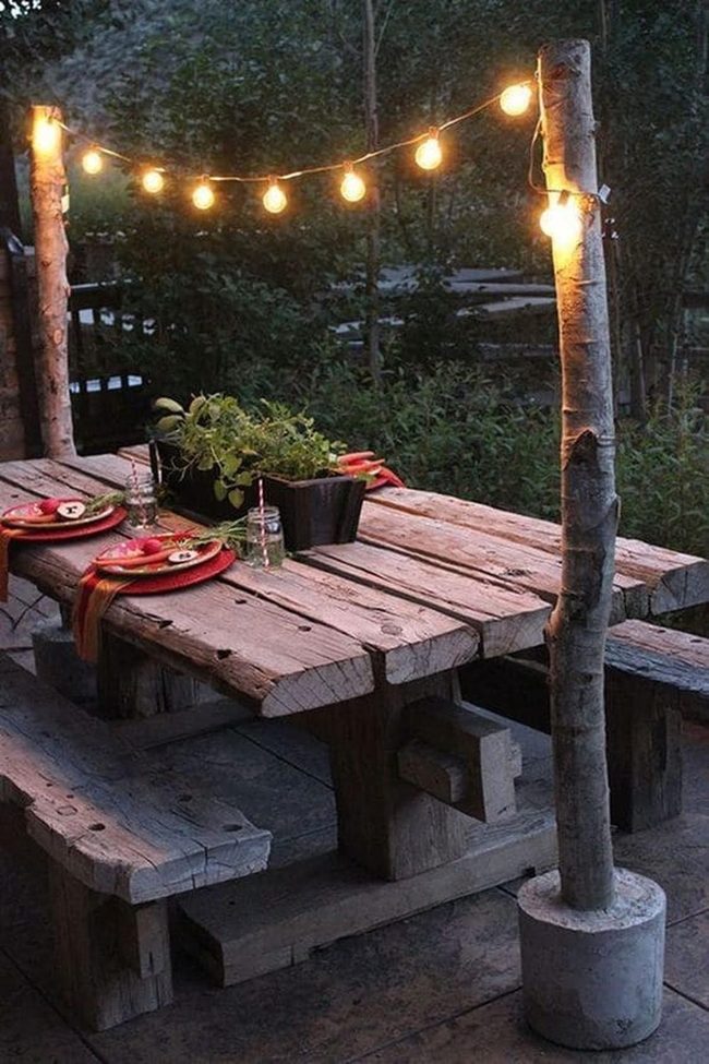 Wooden Tables Stone Patio String Lights