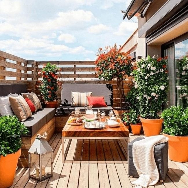 Orange Planters Brighten Wooden Patio