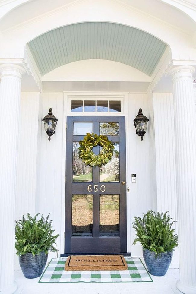 Navy Door Statement With Fresh Greens