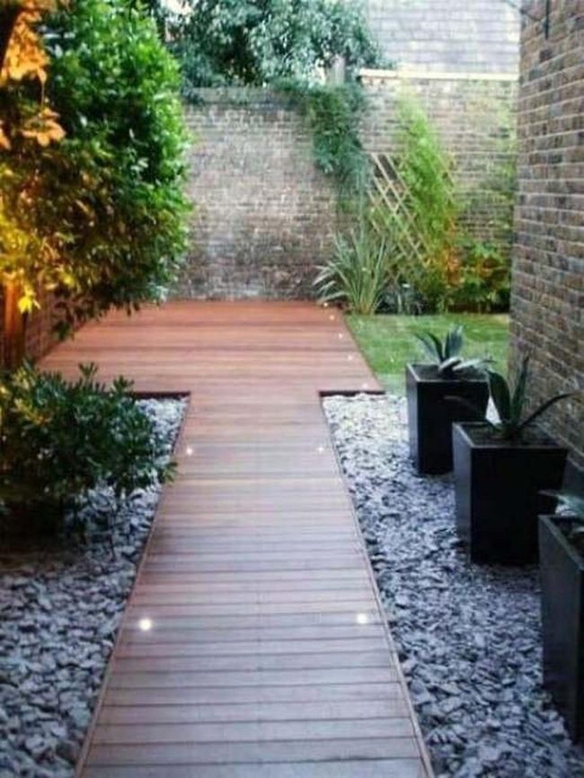 Lit Wooden Paths Through Brick Garden