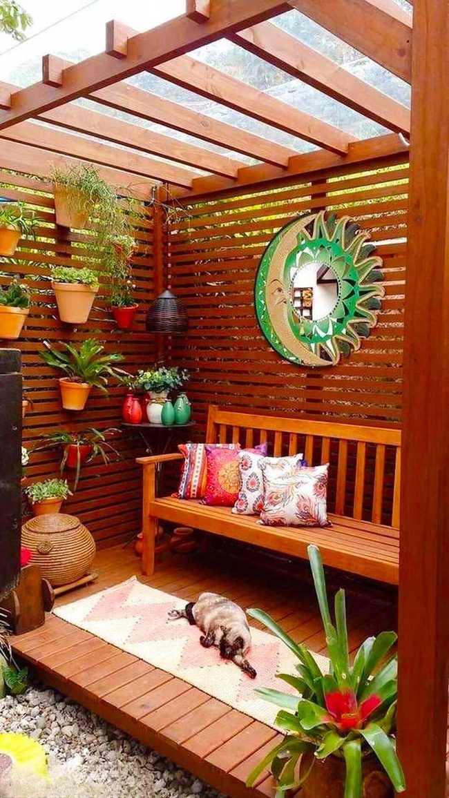 Wooden Bench Among Vertical Plants