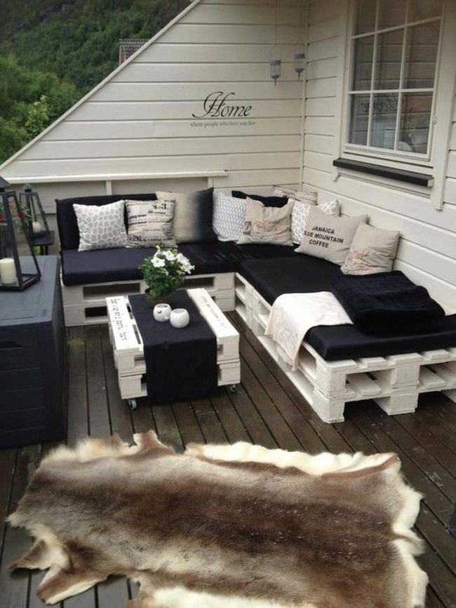White Pallets Dark Cushions Green Plants