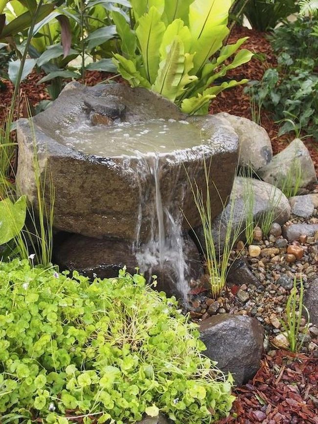 Flowing Stone Fountain Among Green Layers