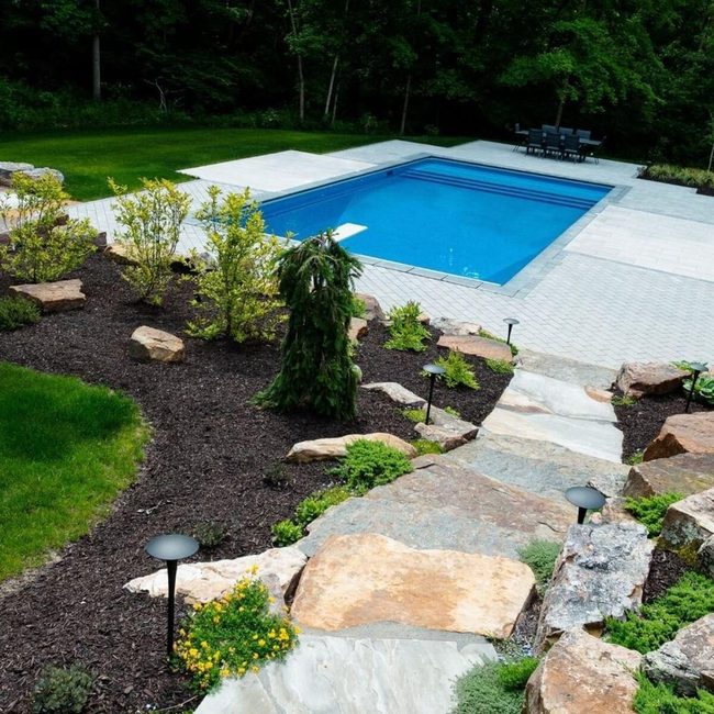 Rich Mulch Frames Stone Pool