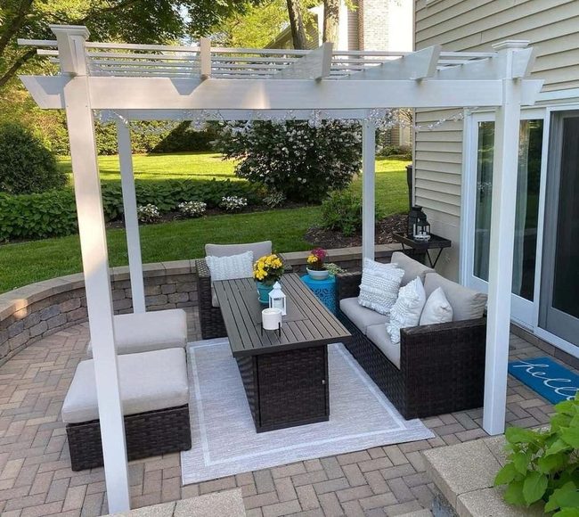 White Pergola With Flowering Garden Space