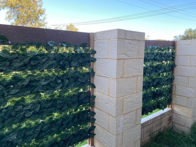 Stone Pillars Embraced By Flourishing Vines
