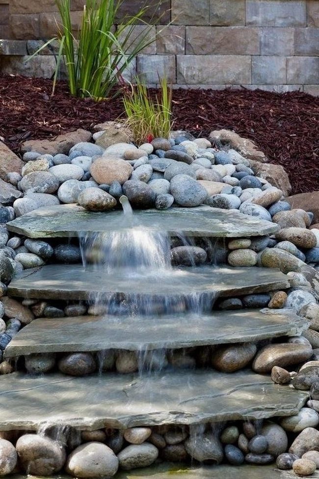 Flowing Gray Stones And Green Plants