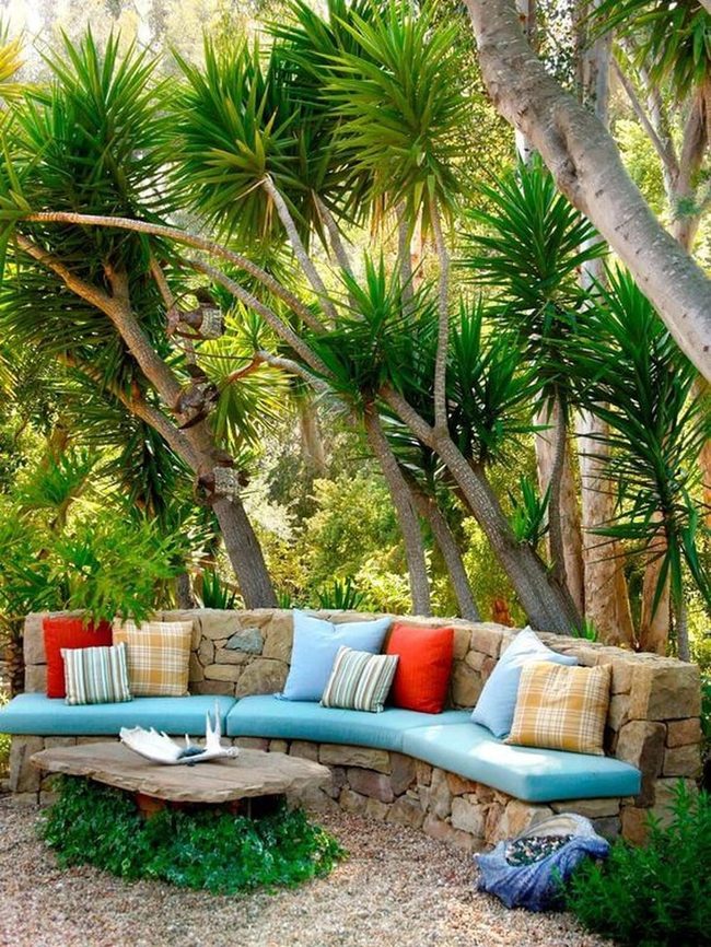Curved Stone Bench Among Vibrant Greens