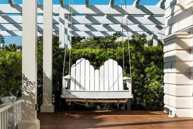 Green Wall White Swings Paradise