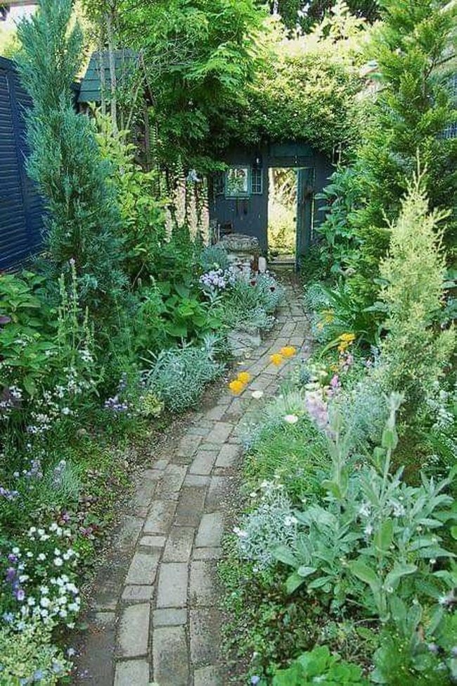 Sunlit Brick Path Through Blooming Garden