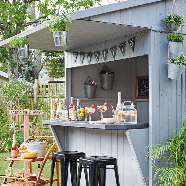 Grey Outdoor Bar With Hanging Greenery