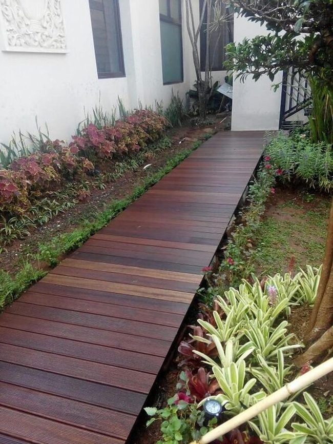 Wooden Path Between White And Garden