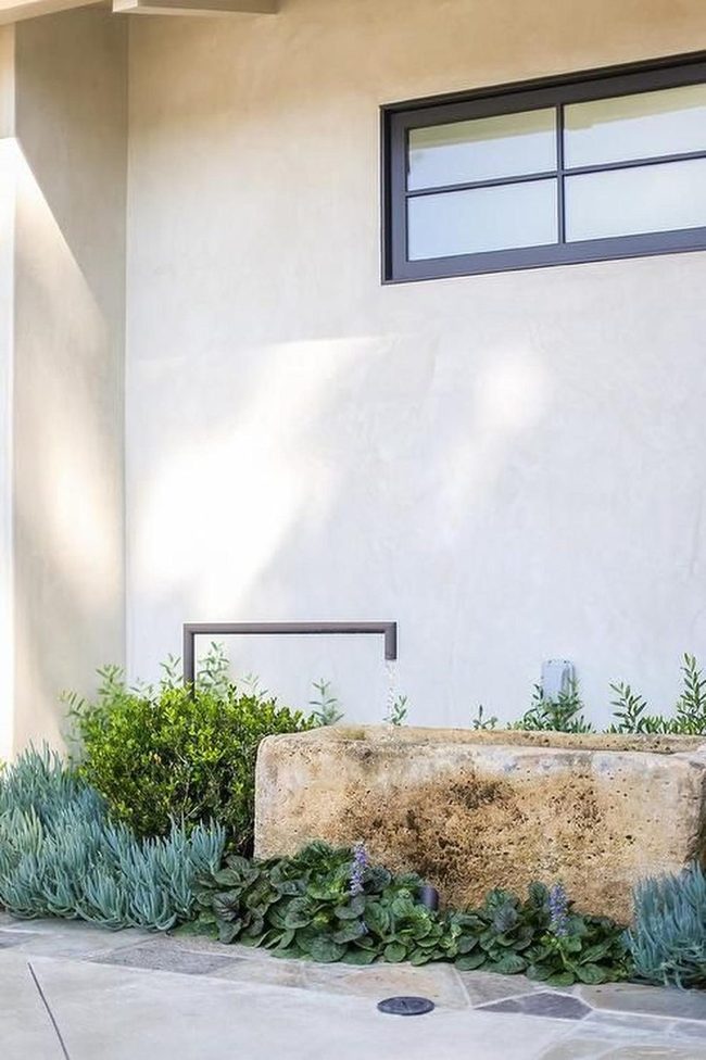 Stone Planters, Green Plants, Sunlit Walls