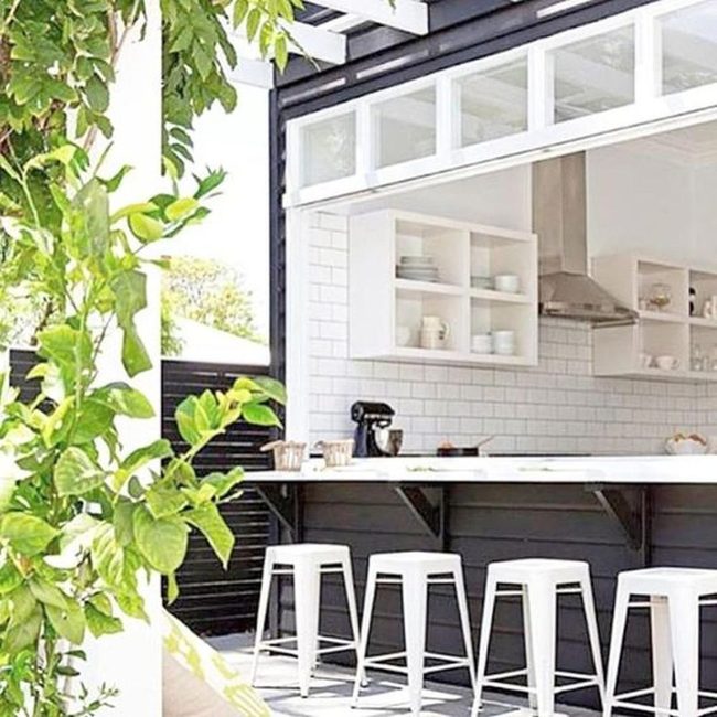 White Tiles, Black Counter, Green Plants
