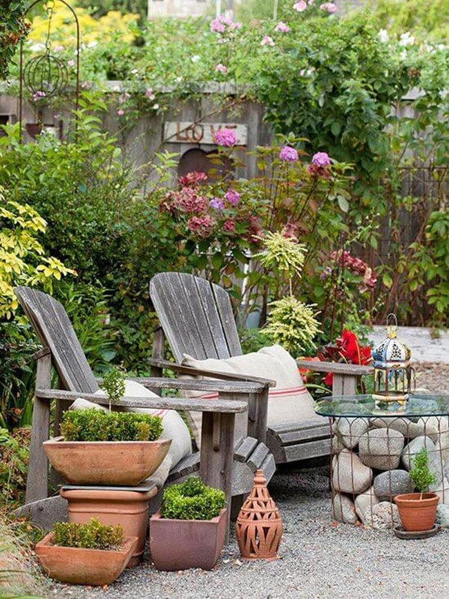 Wooden Chairs Among Blooming Terracotta