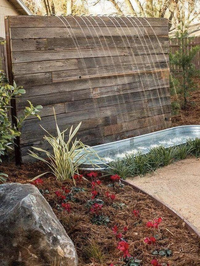 Flowing Water Through Wooden Garden Sanctuary