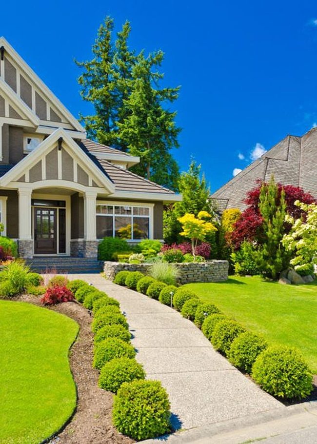 Stone-Framed Garden With Manicured Hedges