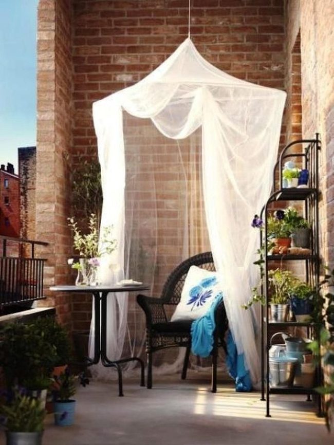 Brick Balcony With Billowing White Curtains