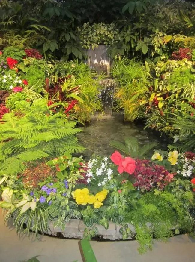 Waterfall Garden With Red And Yellow Flowers
