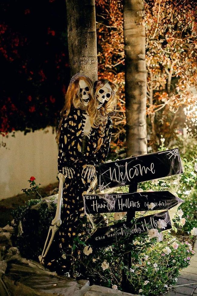 Skeleton Figures Among Blooming Garden