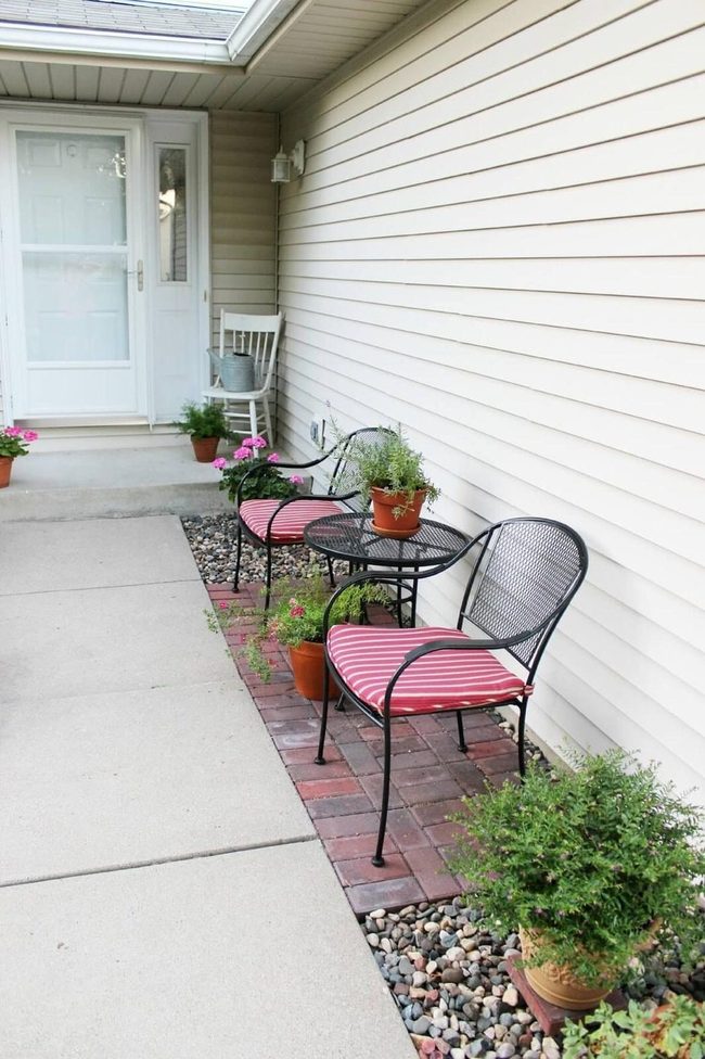 Pink Striped Seating Among Blooming Potted Plants