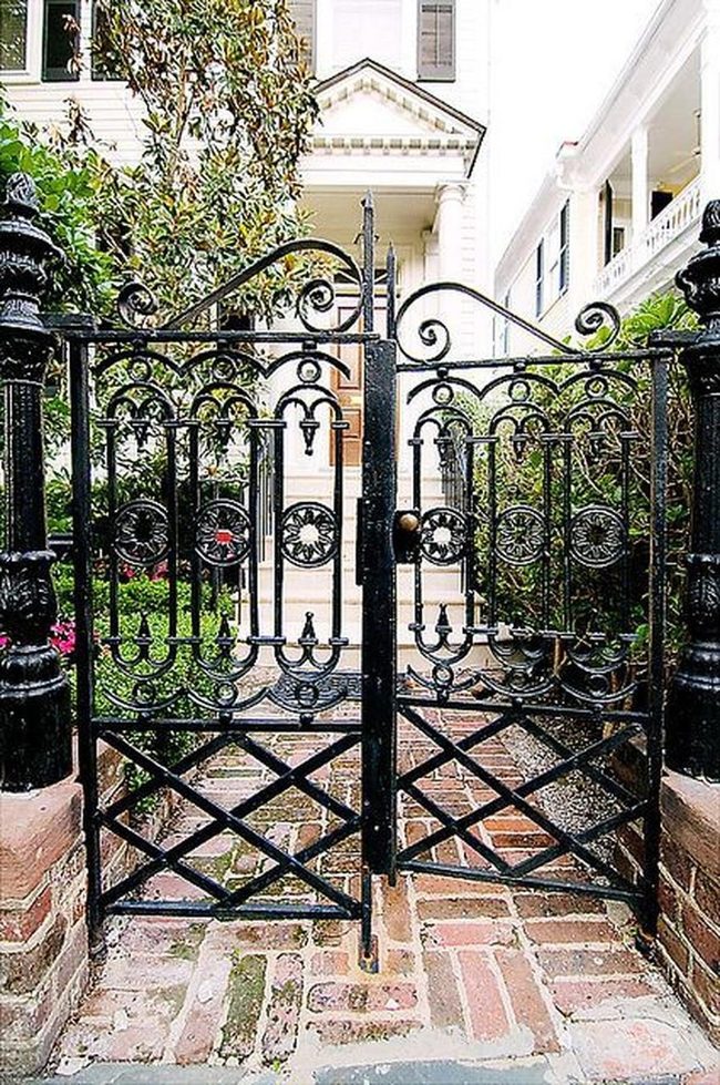Black Iron Gates With Brick Pathways