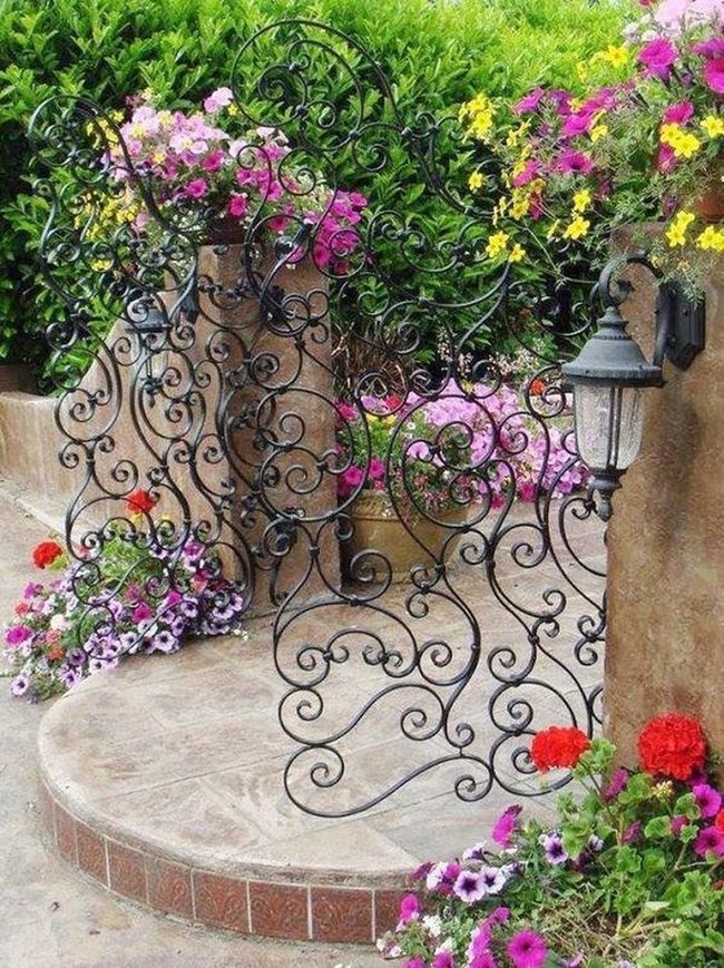 Ornate Iron Gates With Blooming Flowers