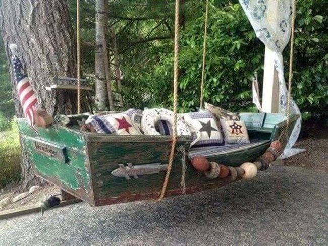 Weathered Wood Boat With Patterned Cushions