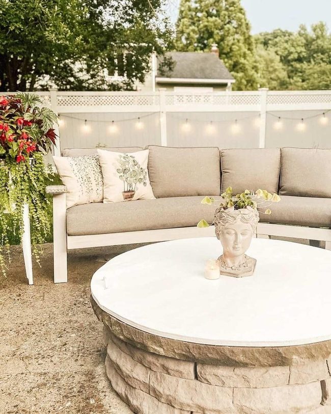 Ivy-Draped Bust Among Blooming White Planters